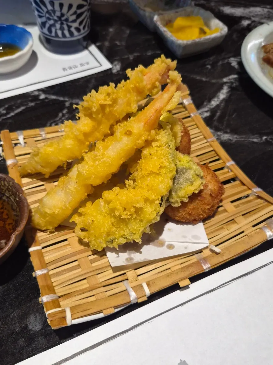 Assortment of shrimp tempura, sweet pumpkin, eggplant tempura, and potato croquette