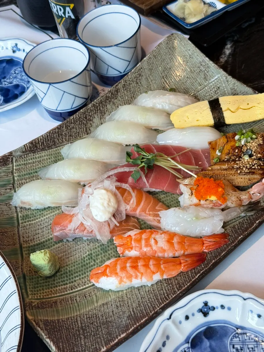 Various sushi pieces including flounder, salmon, and tuna