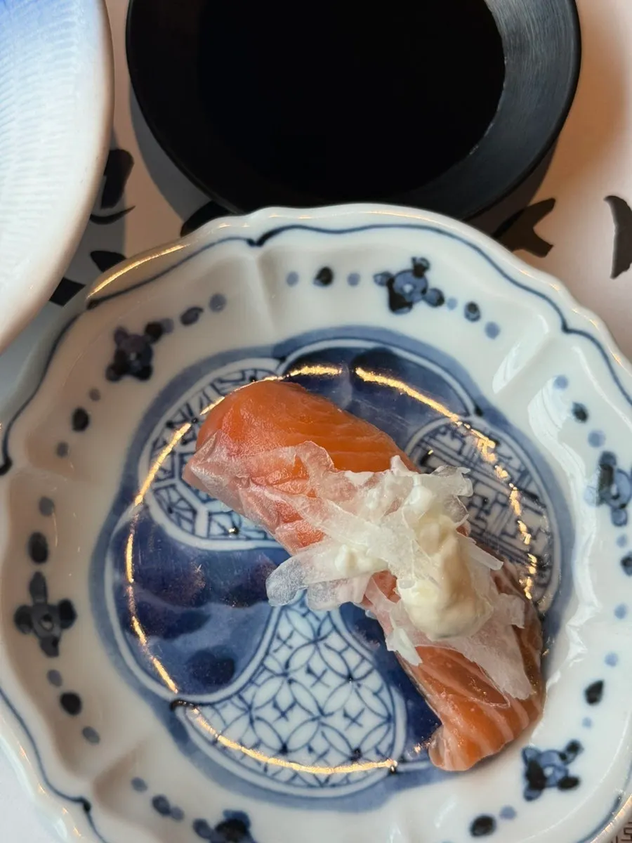 Salmon sushi topped with sauce