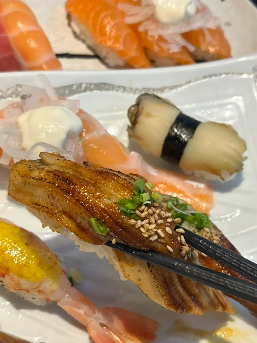 Close-up of sushi topped with thick cuts of fish