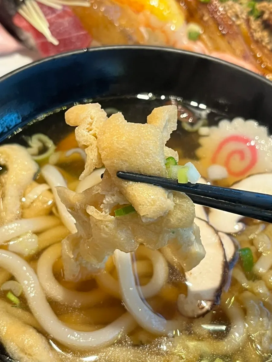 A chopstick-full of chewy udon noodles