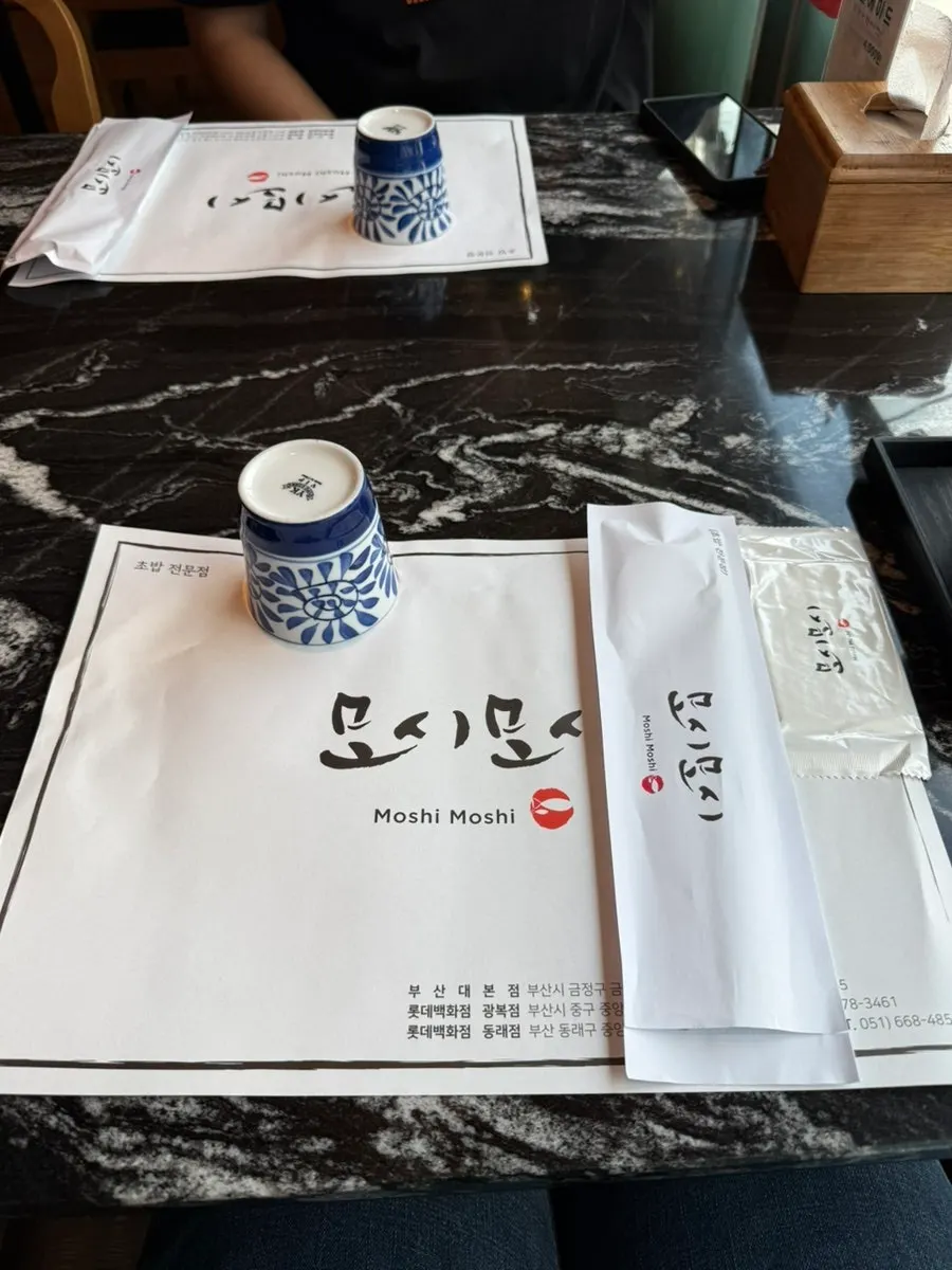 Chopsticks, wet wipes, and cups set out per person