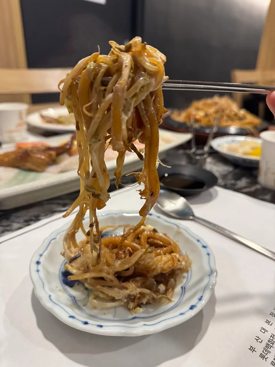 Vertical shot of soy-marinated shrimp and raw shrimp sushi