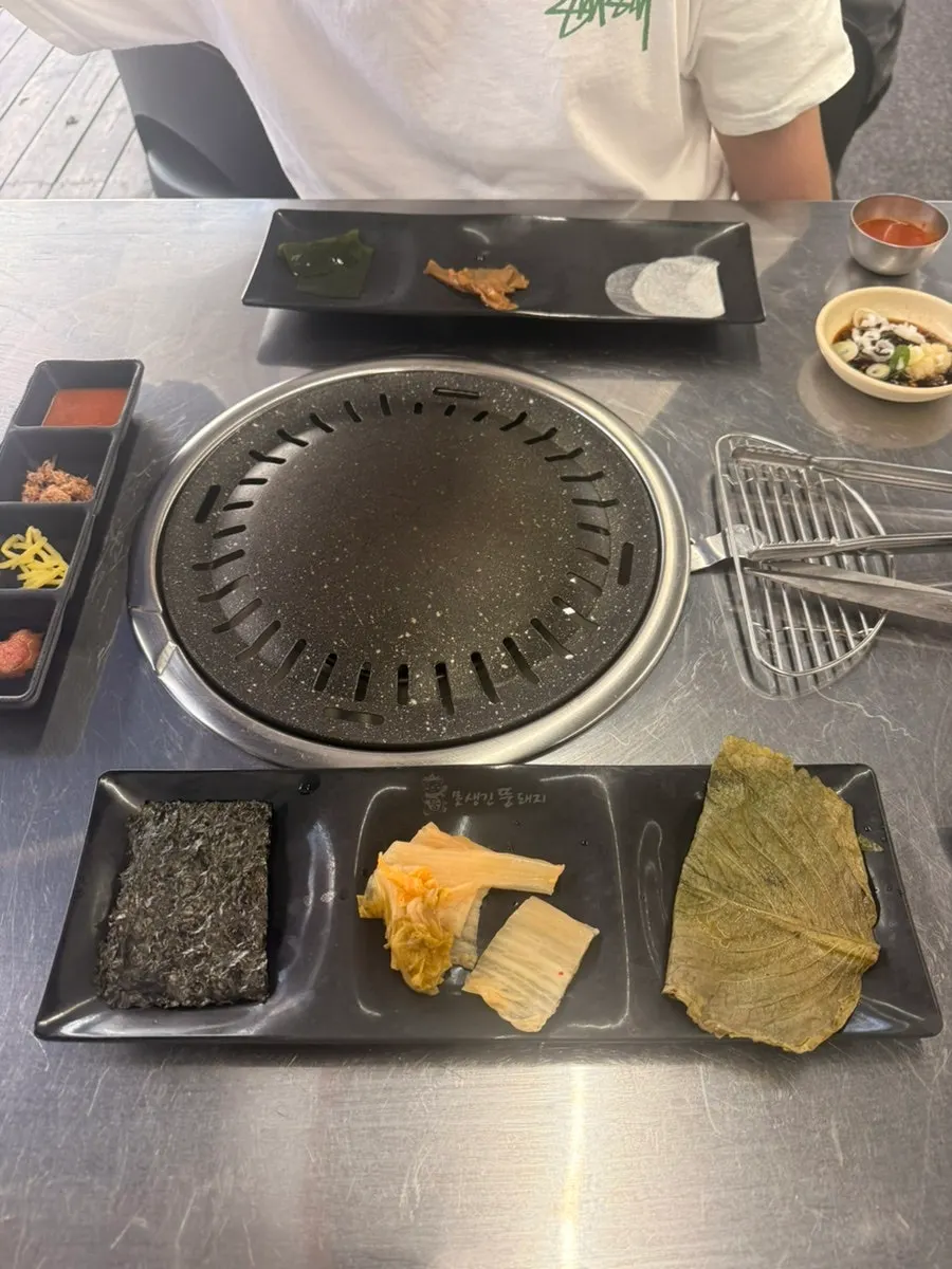 Basic side dish spread with seaweed, white kimchi, pickled perilla leaves, and more