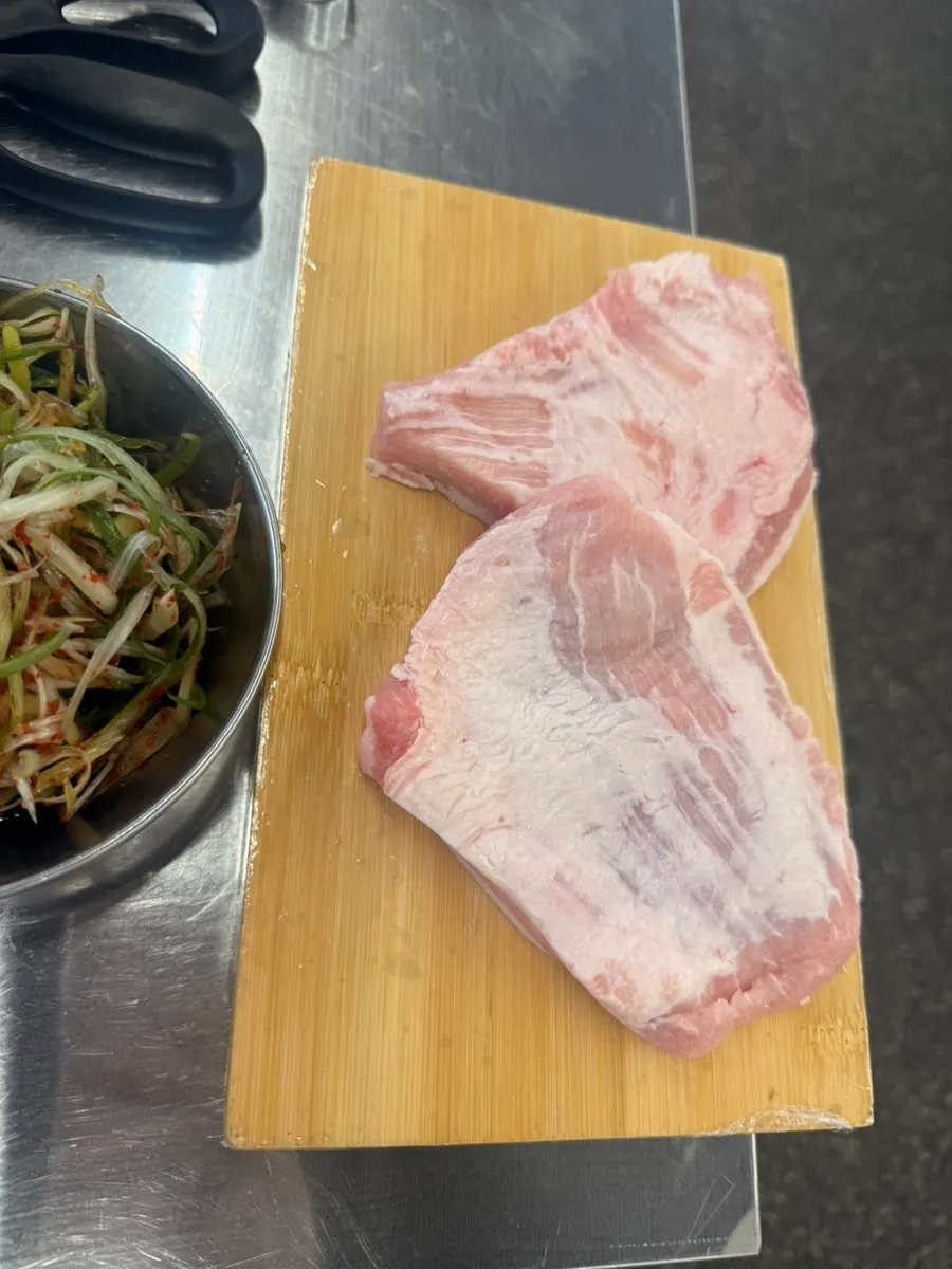 Plate of pink raw pork jowl for two