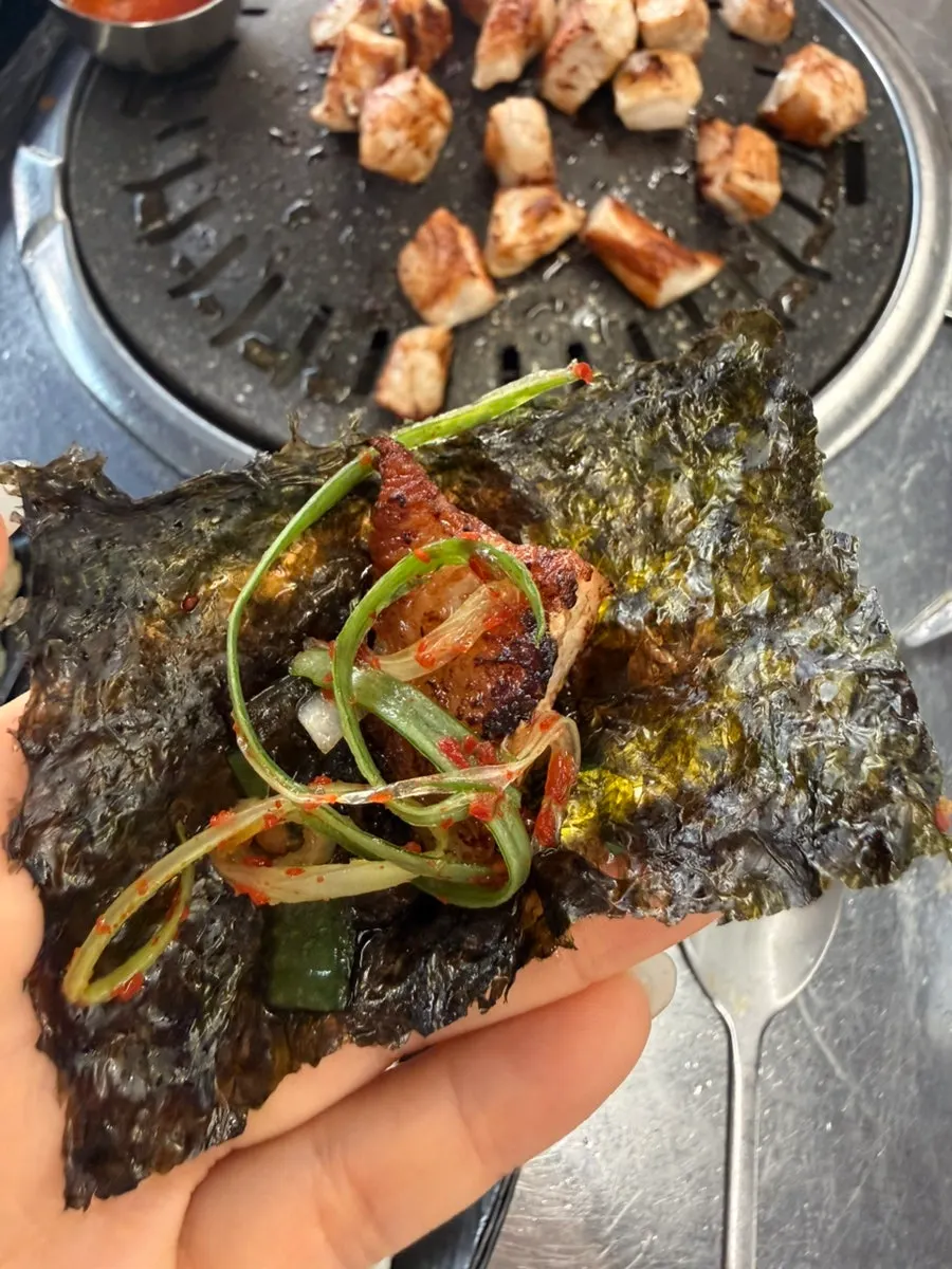 Wrap of pork jowl, salted pollack roe, and pickled green onion in seaweed