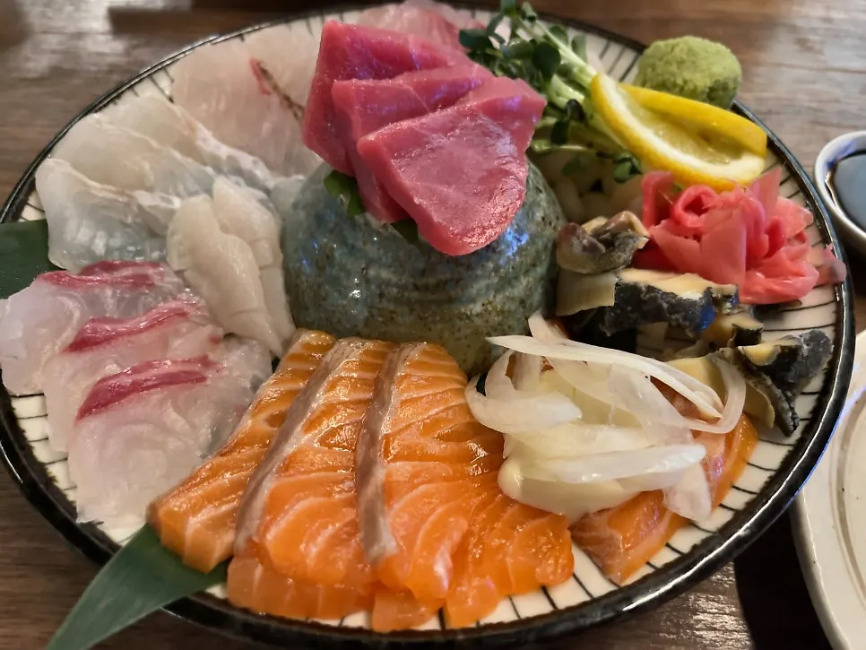 A thick-cut piece of sashimi at Motokurashi