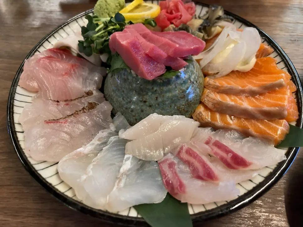 Sashimi picked up with chopsticks