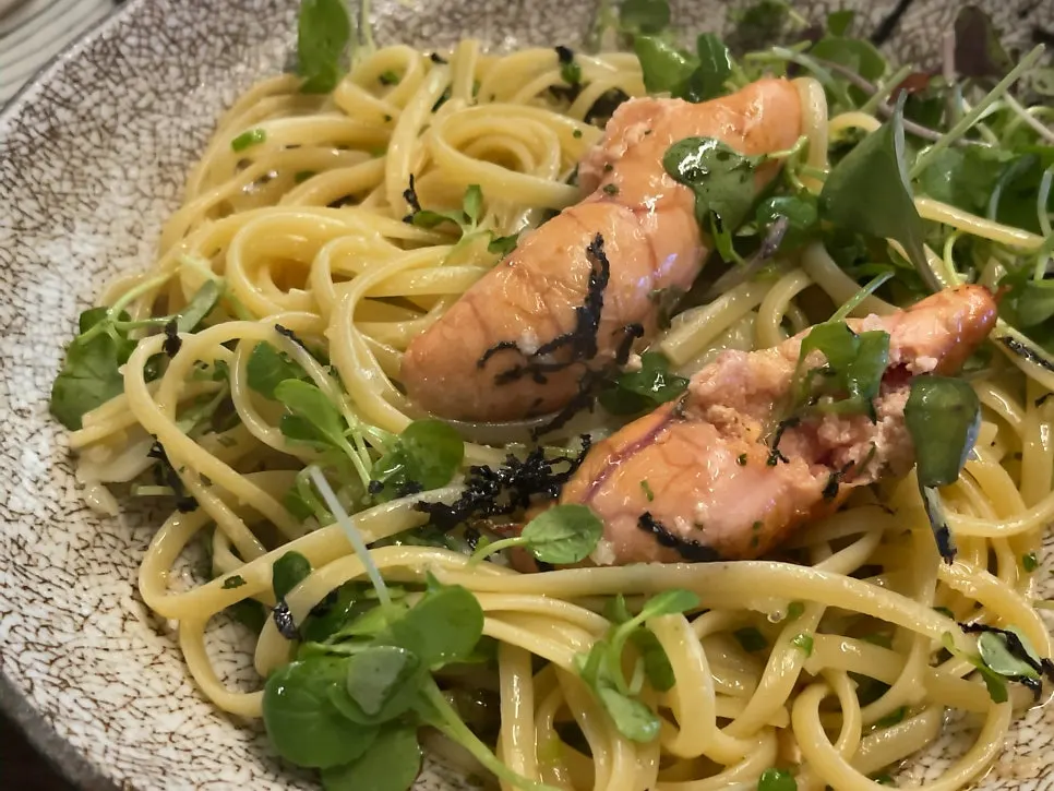 Mentaiko flying fish roe pasta served alongside sashimi
