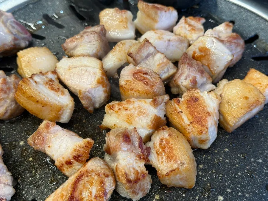 Raw pork ribs grilling to a golden brown