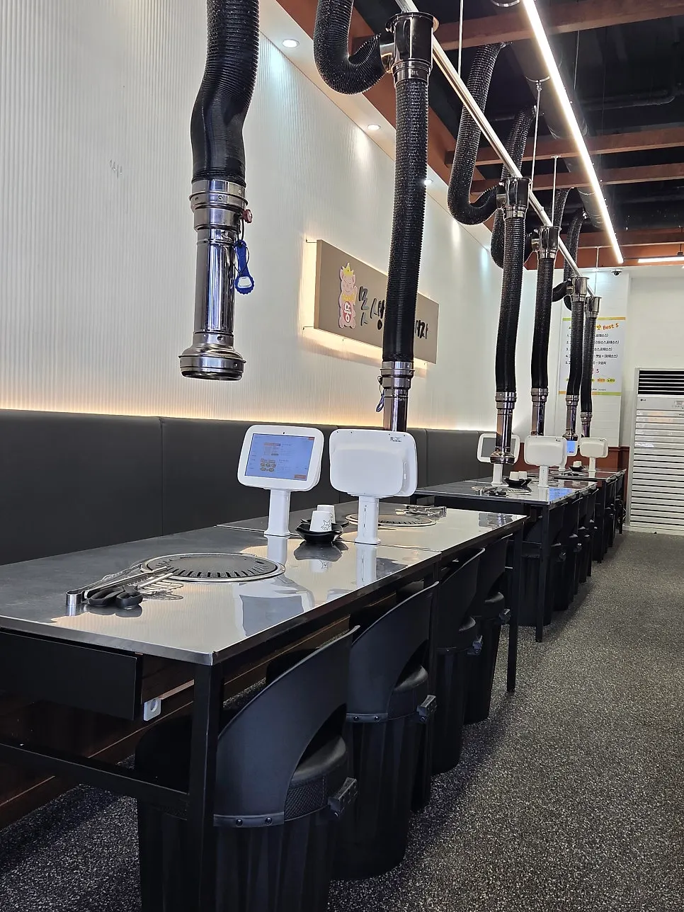 A duct hanging over each table