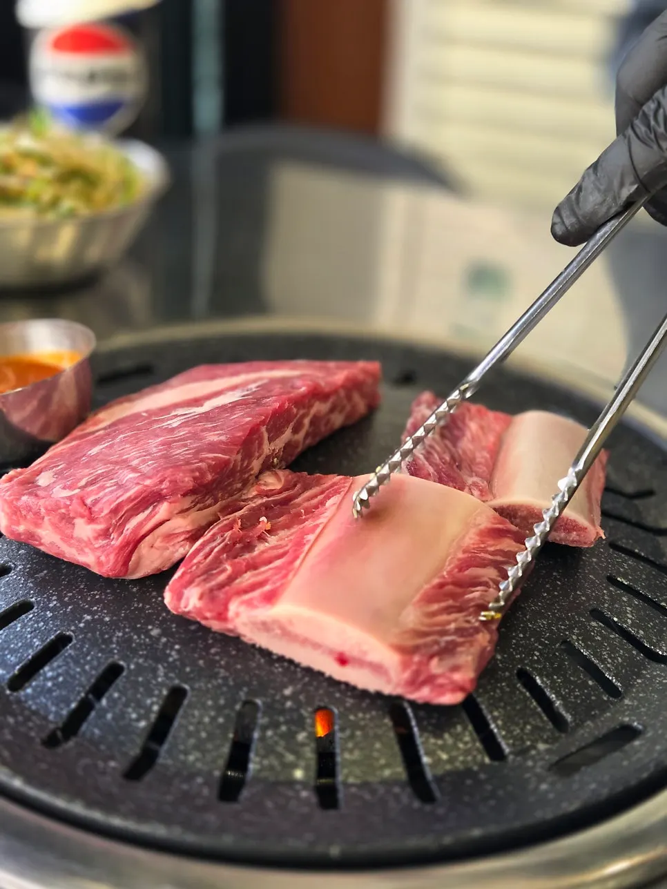 Thick raw ugalbi (beef rib) still on the bone