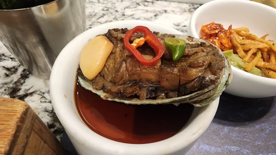 Soy-braised abalone, pickles and roasted seaweed side dishes
