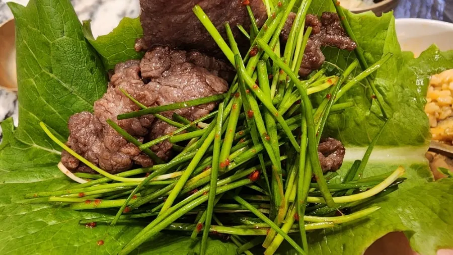 Charcoal-grilled hanwoo served with chive salad