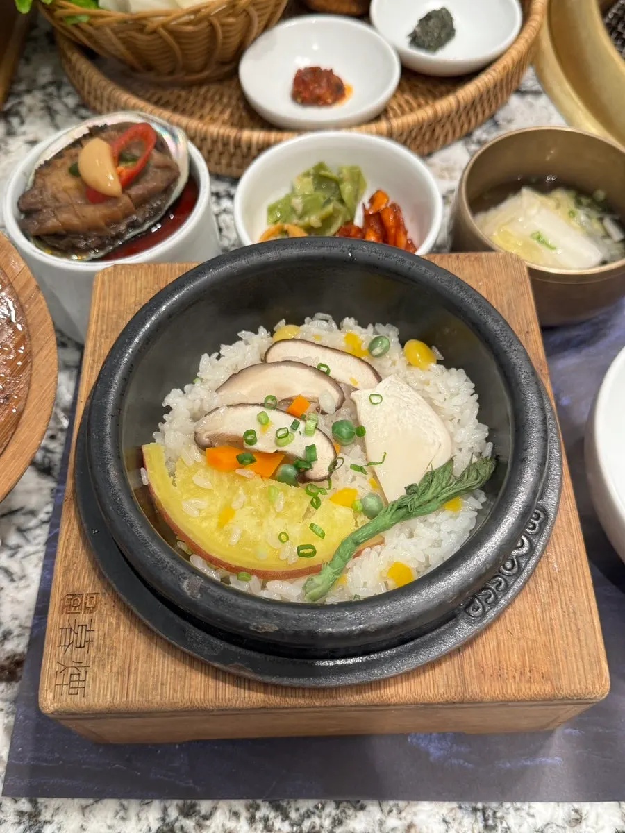 Abalone pot rice topped with ginkgo nuts, sweet potato, and mushrooms
