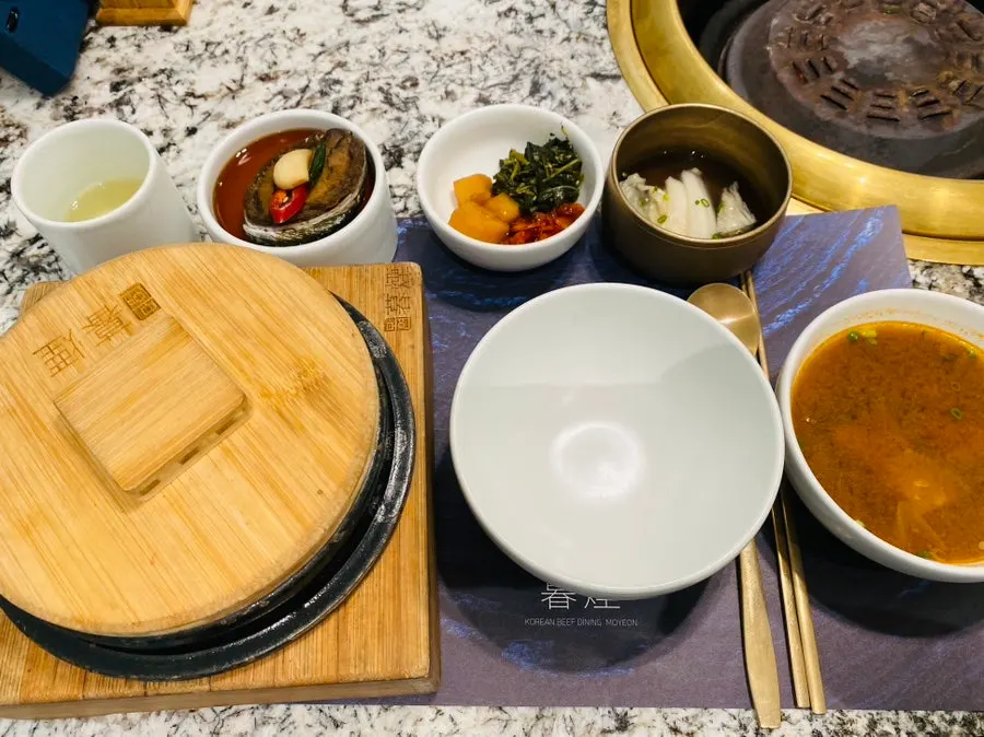 Basic side dish spread with lettuce wraps, three side dishes and white kimchi