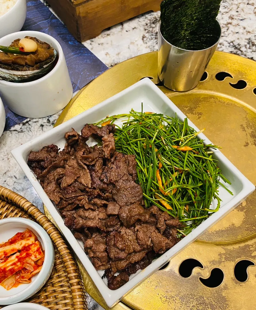 A bite of charcoal-grilled hanwoo with nutrition chives