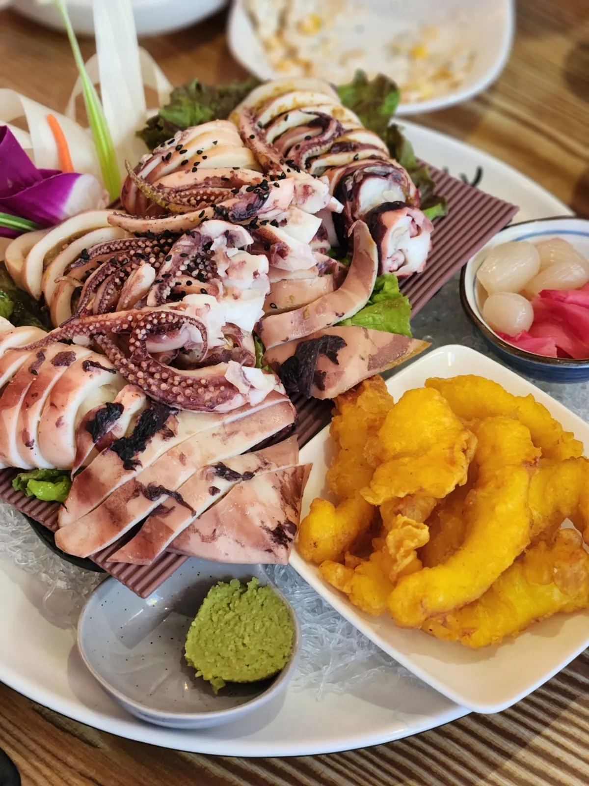 A table of four whole braised squid
