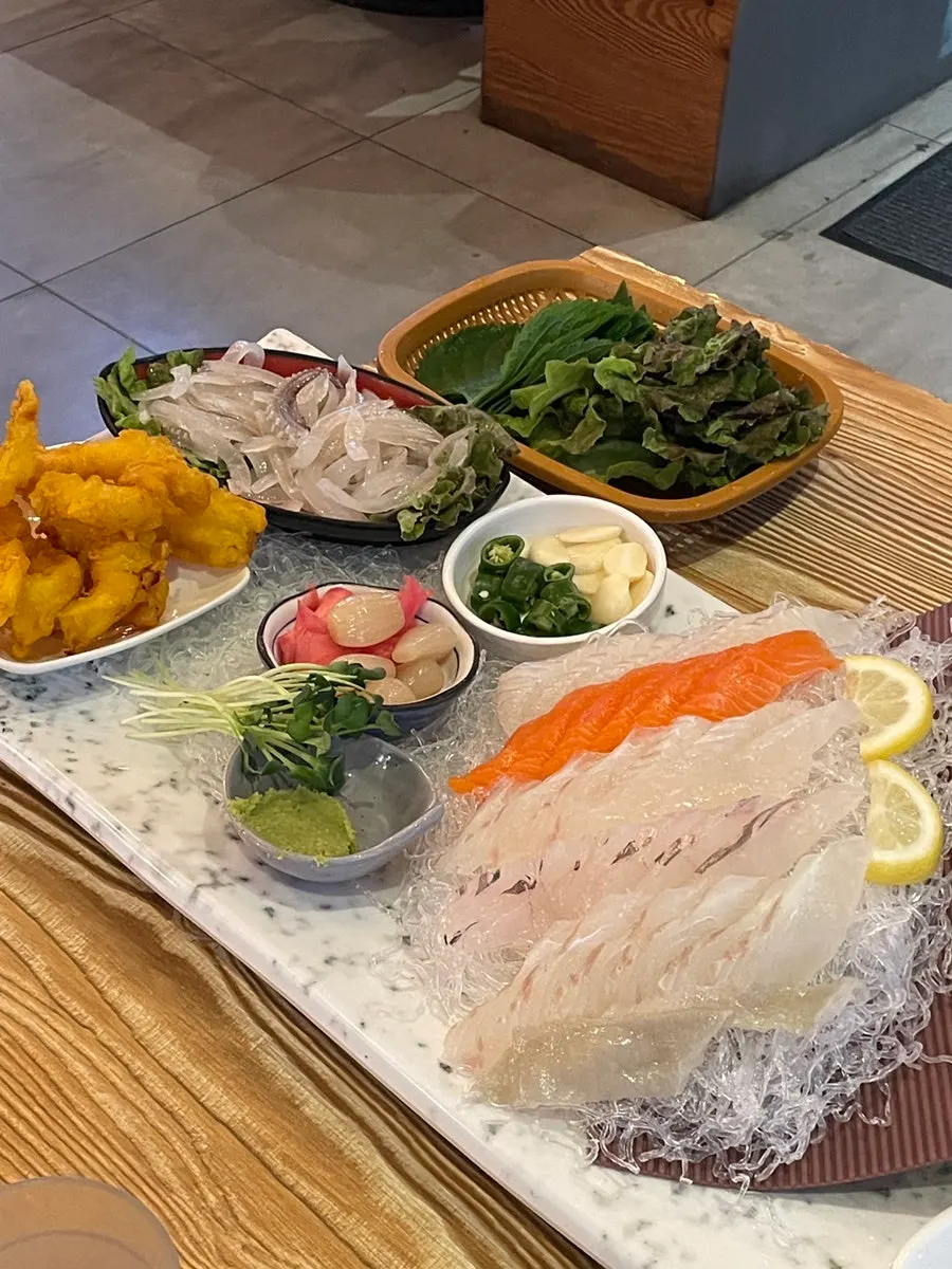 Full table with squid sashimi and raw fish sashimi
