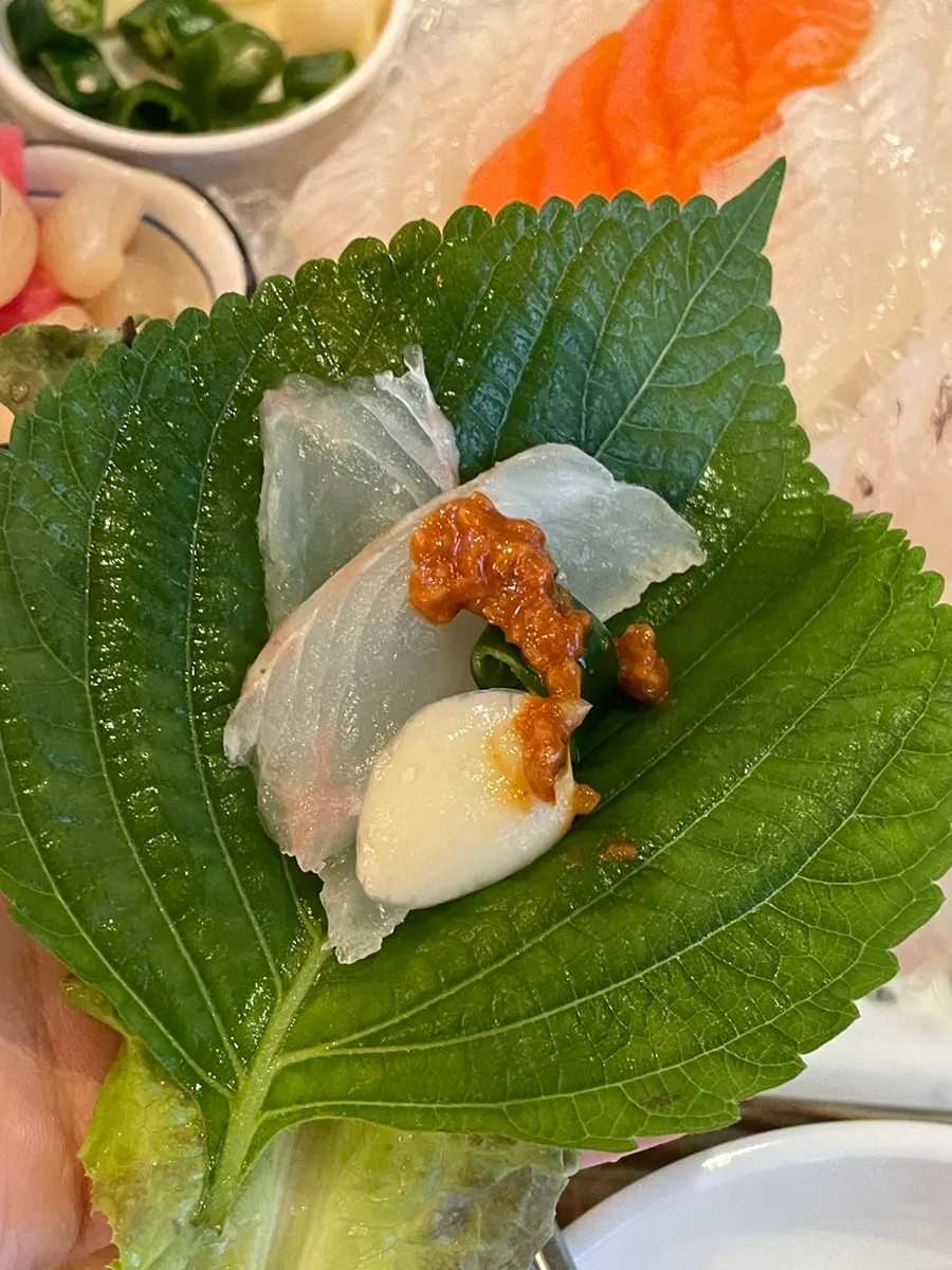 Squid sashimi and ssamjang wrapped in lettuce