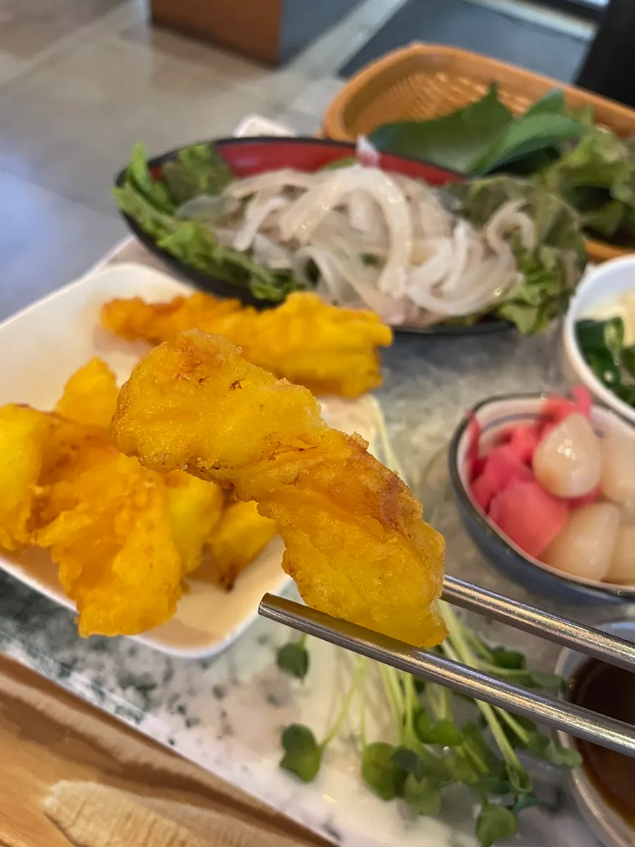 A wrap of sashimi with aged kimchi