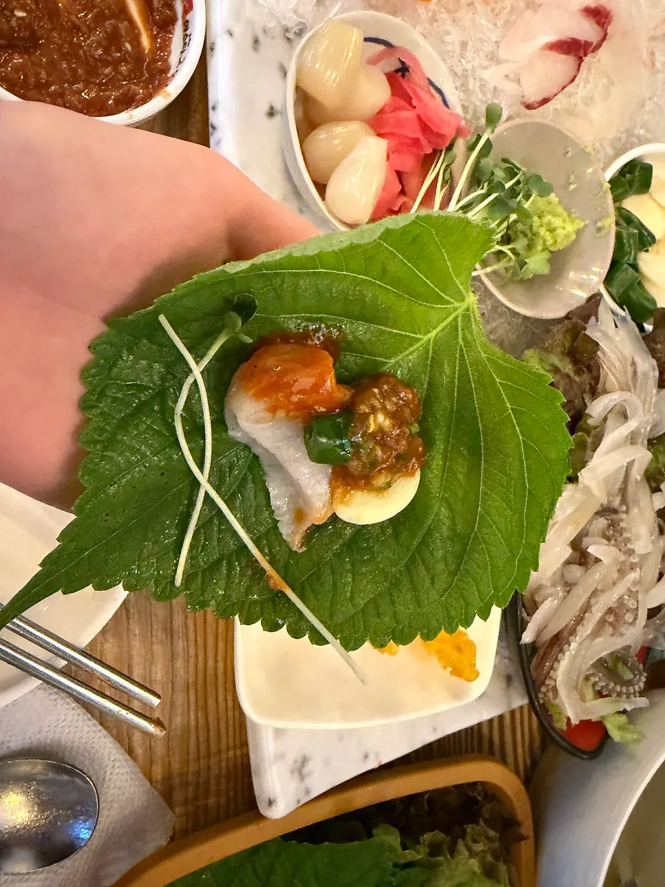 Picking up a piece of fish sashimi