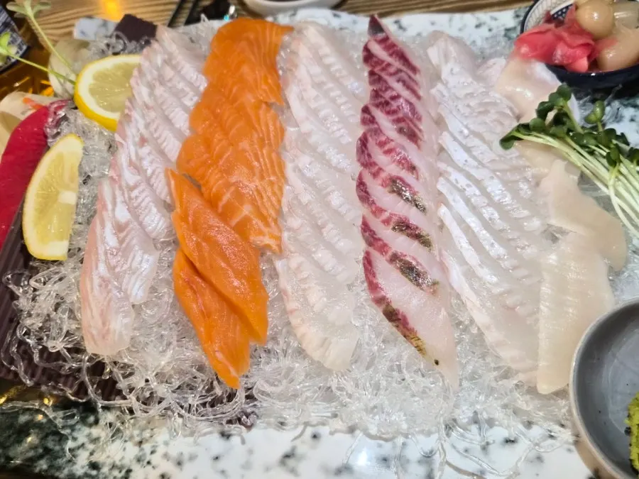 Full table spread with medium assorted sashimi and steamed egg