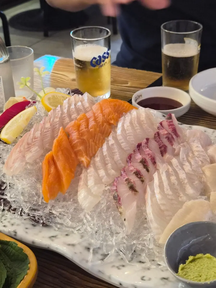Vertical photo of the table midway through the sashimi meal