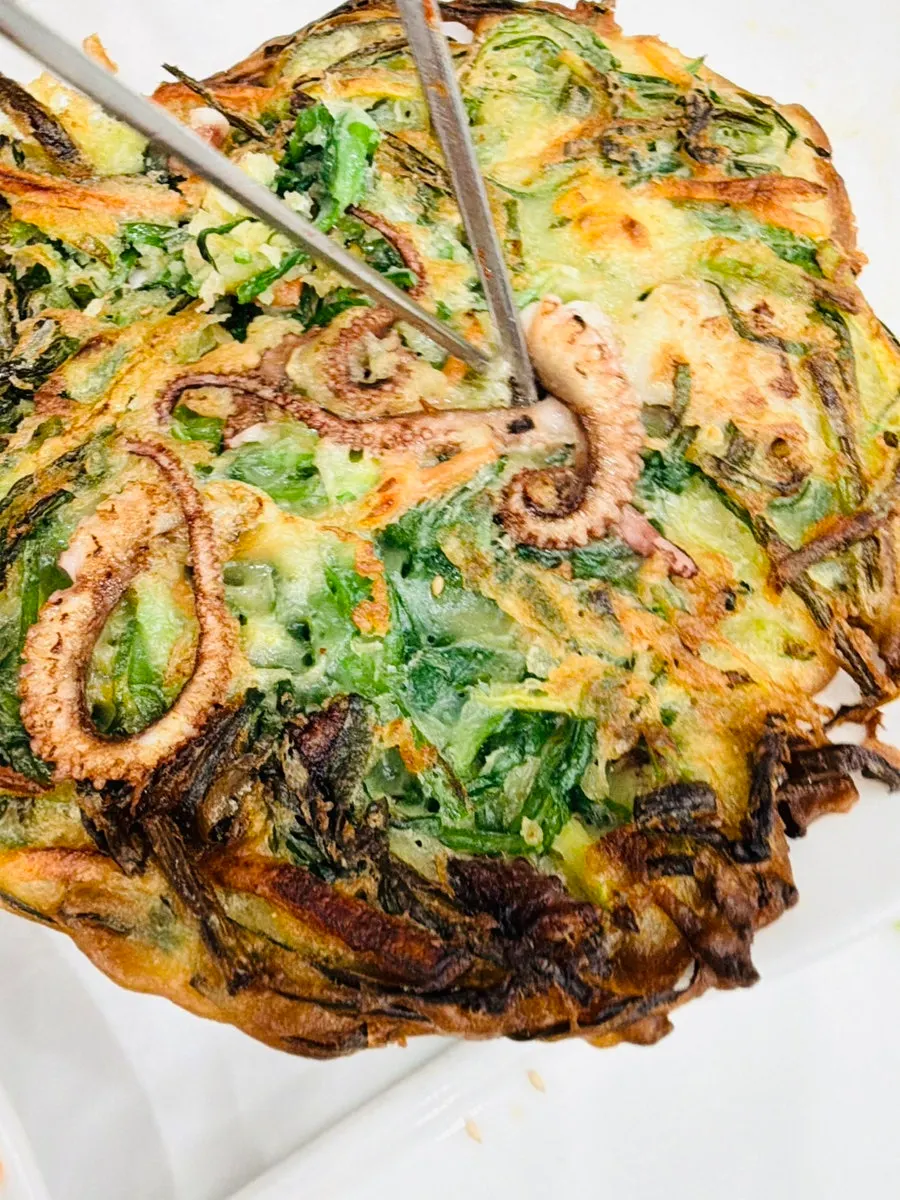 Side dishes of soy-marinated raw crab, tteokgalbi, and octopus jeon