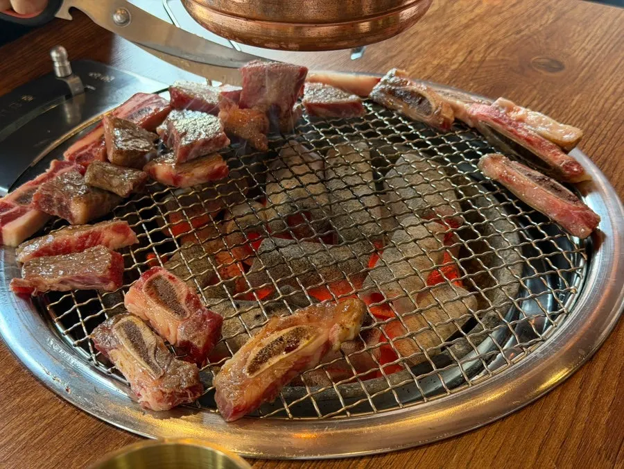 Fresh beef ribs grilling over charcoal