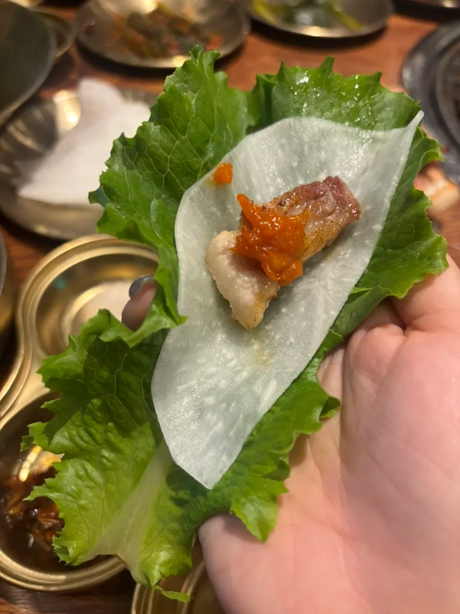 A piece of fresh pork ribs paired with raw onion and sauce