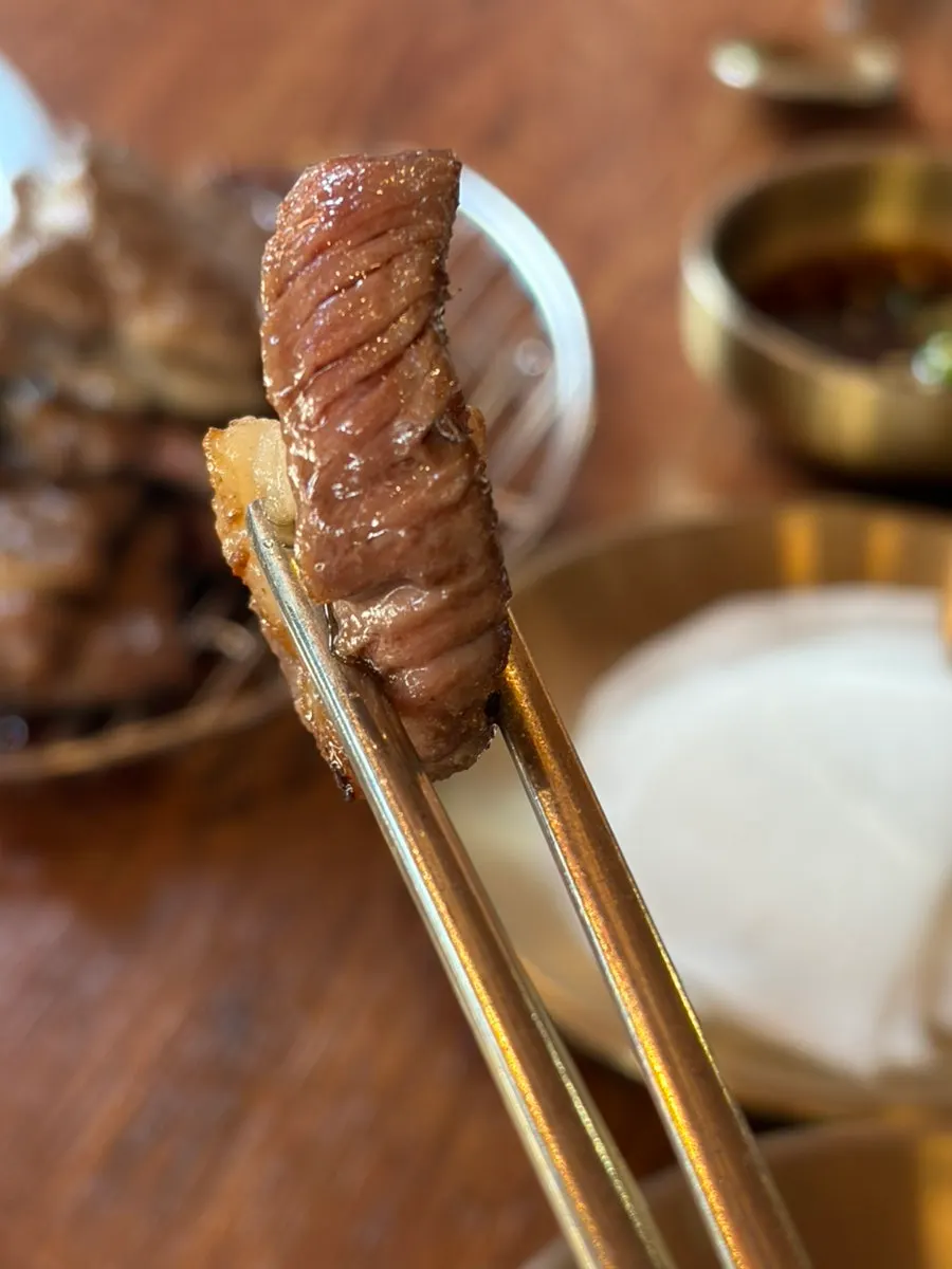 Fully cooked rib meat moved to the side of the grill