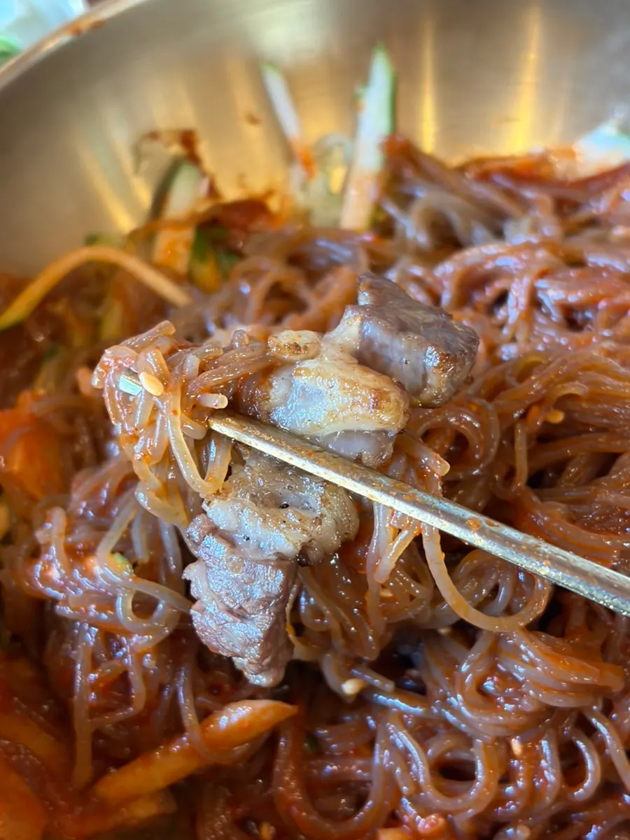 Chopsticks lifting bibim naengmyeon noodles