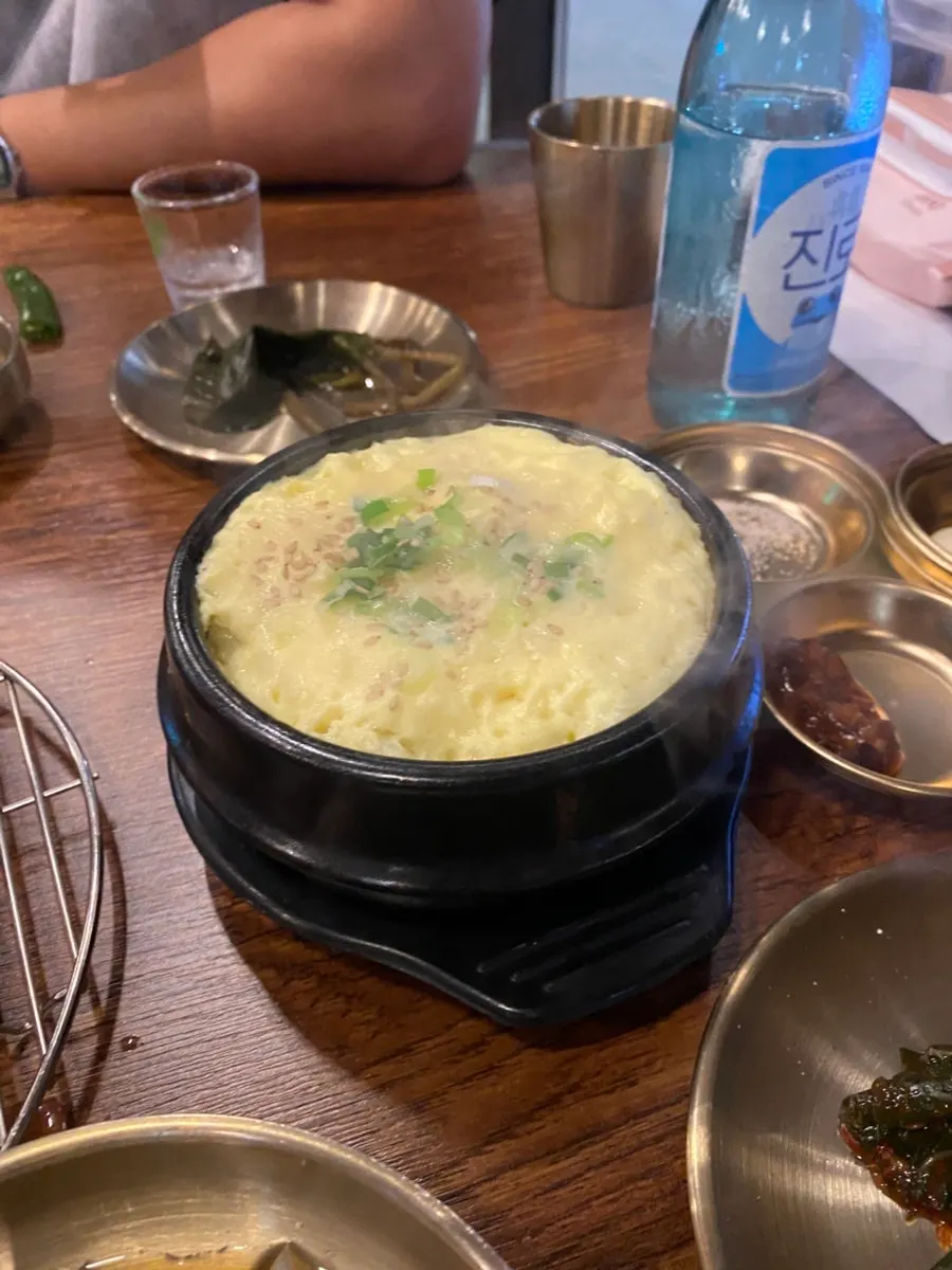 A bottle of soju with the meat spread