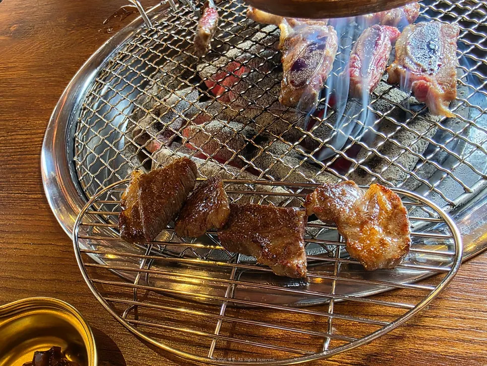Grilled beef rib meat stacked over charcoal