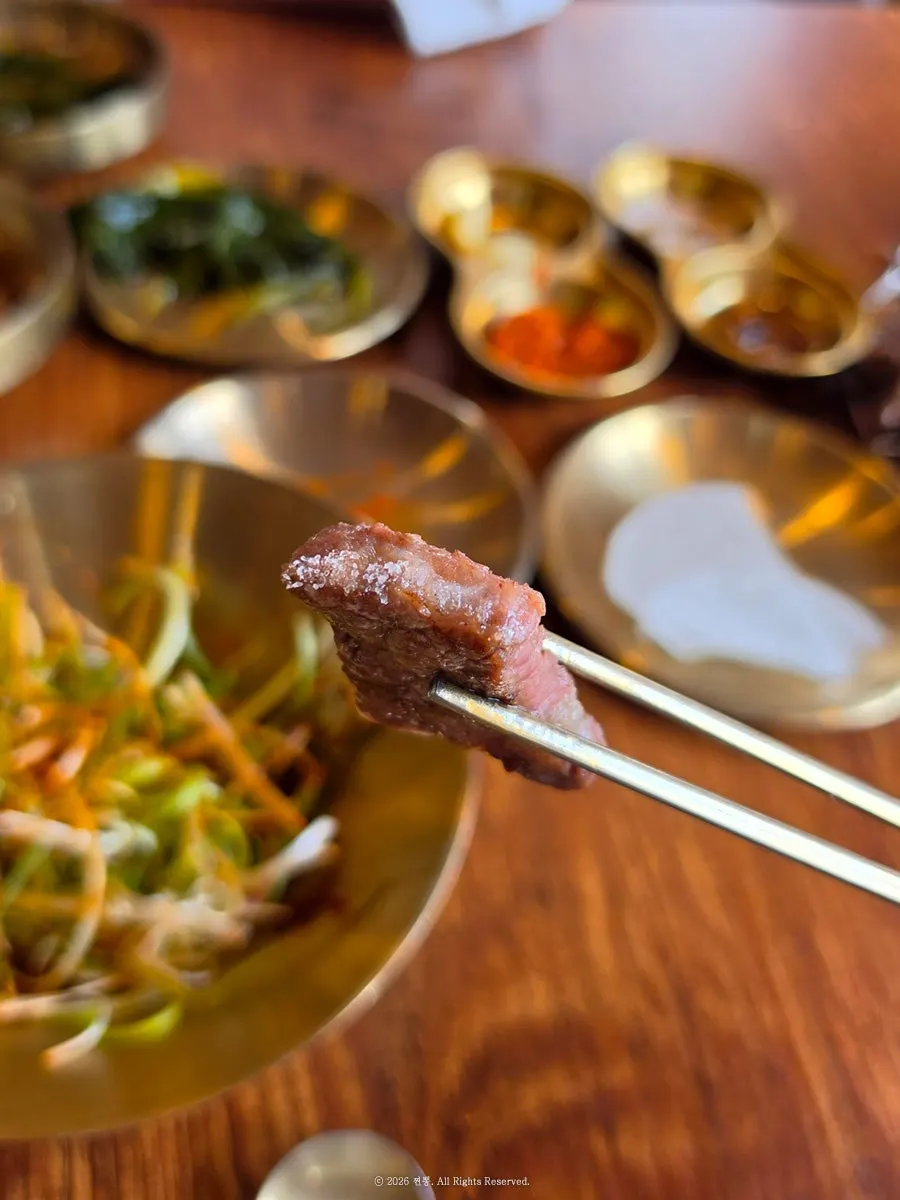 A piece of beef rib meat dipped in salt