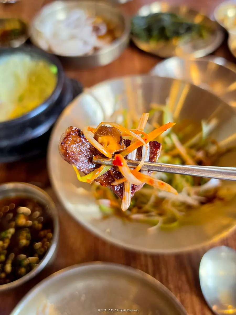 Beef ribs topped with shiitake wasabi sauce and scallion salad
