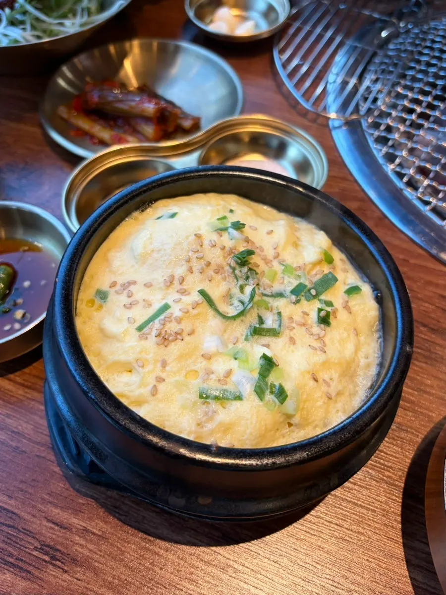 Side dish spread with mountain herbs, ssam radish, and mustard leaf kimchi