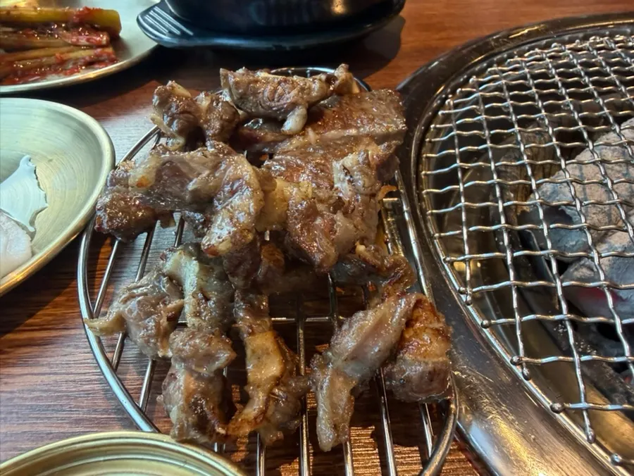 Ribs with meat beside the bone being grilled