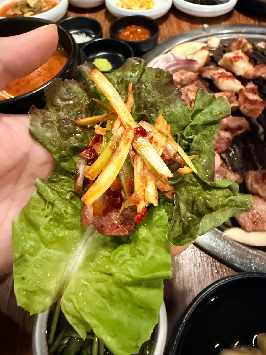 A piece of thick pork neck dipped in salt