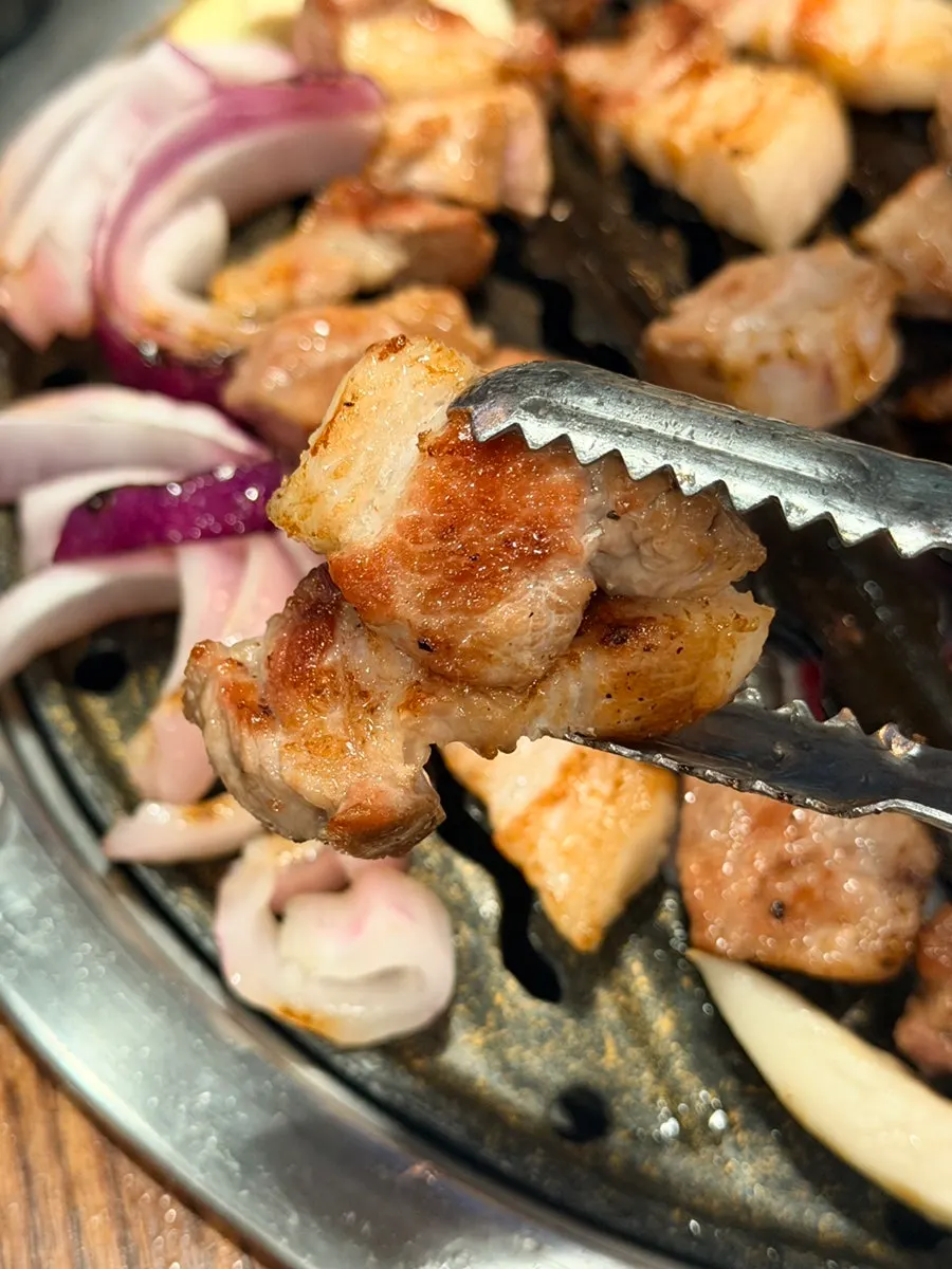 A bite of pork belly combined with side dishes