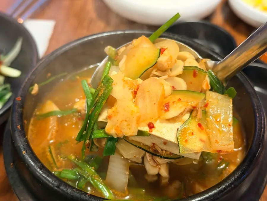 Table spread with doenjang jjigae and soju