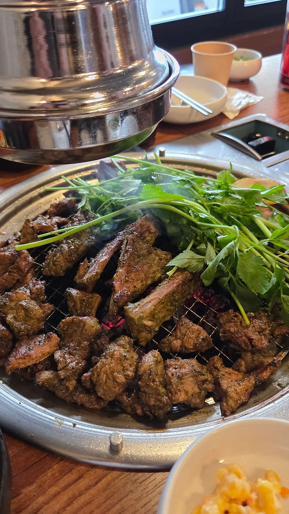 Matcha ribs cooking on the grill, turning into a seasoned galbi color