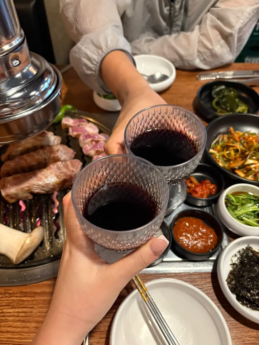 Glass of red wine served alongside the grilled meat