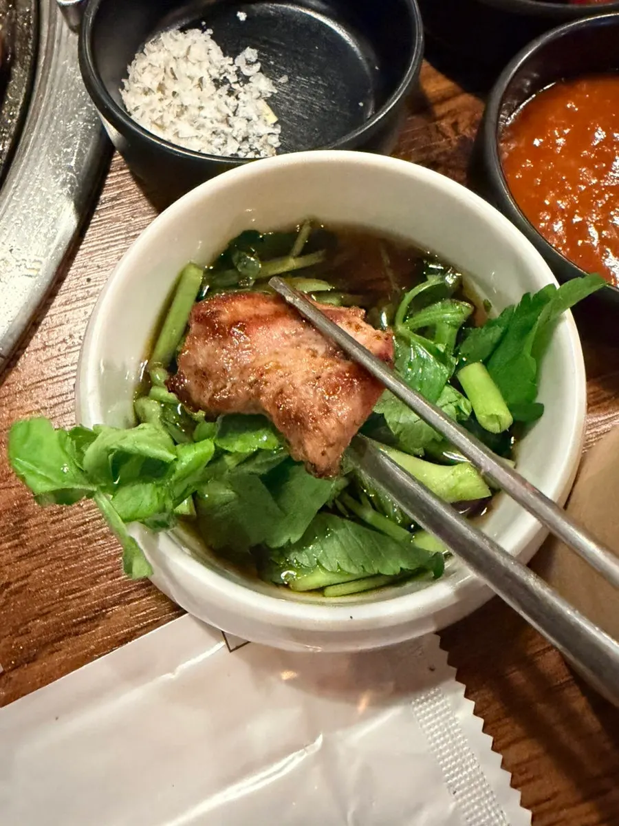 A piece of galmaegisal dipped in garlic sauce