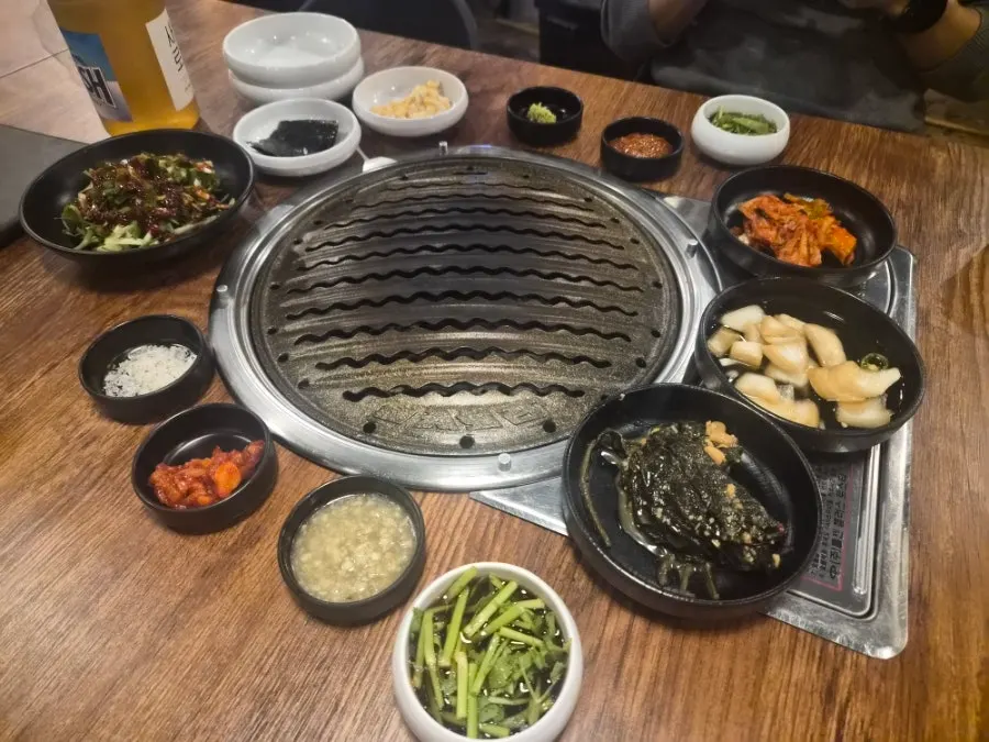 Side dish spread at Muttuk including shredded scallions and kimchi