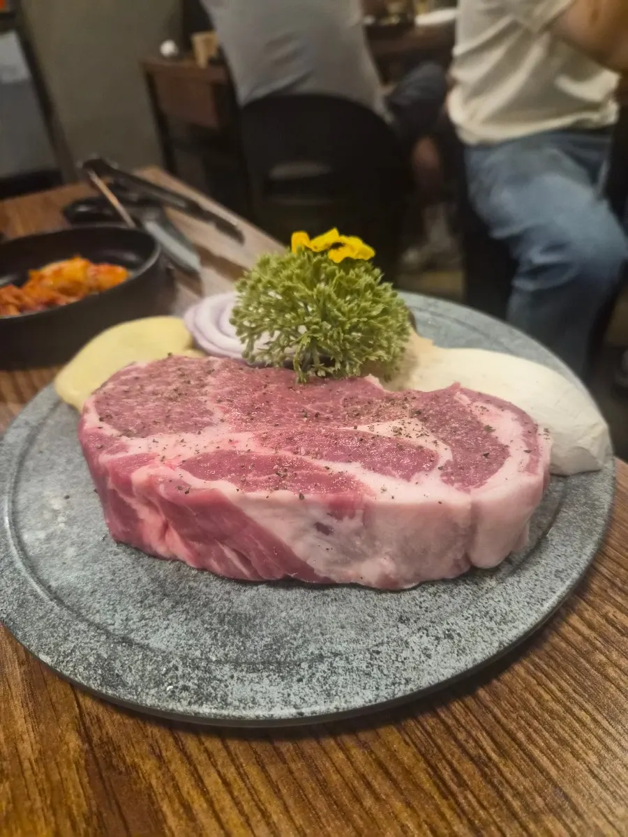 Plate of thick pork neck garnished with flowers