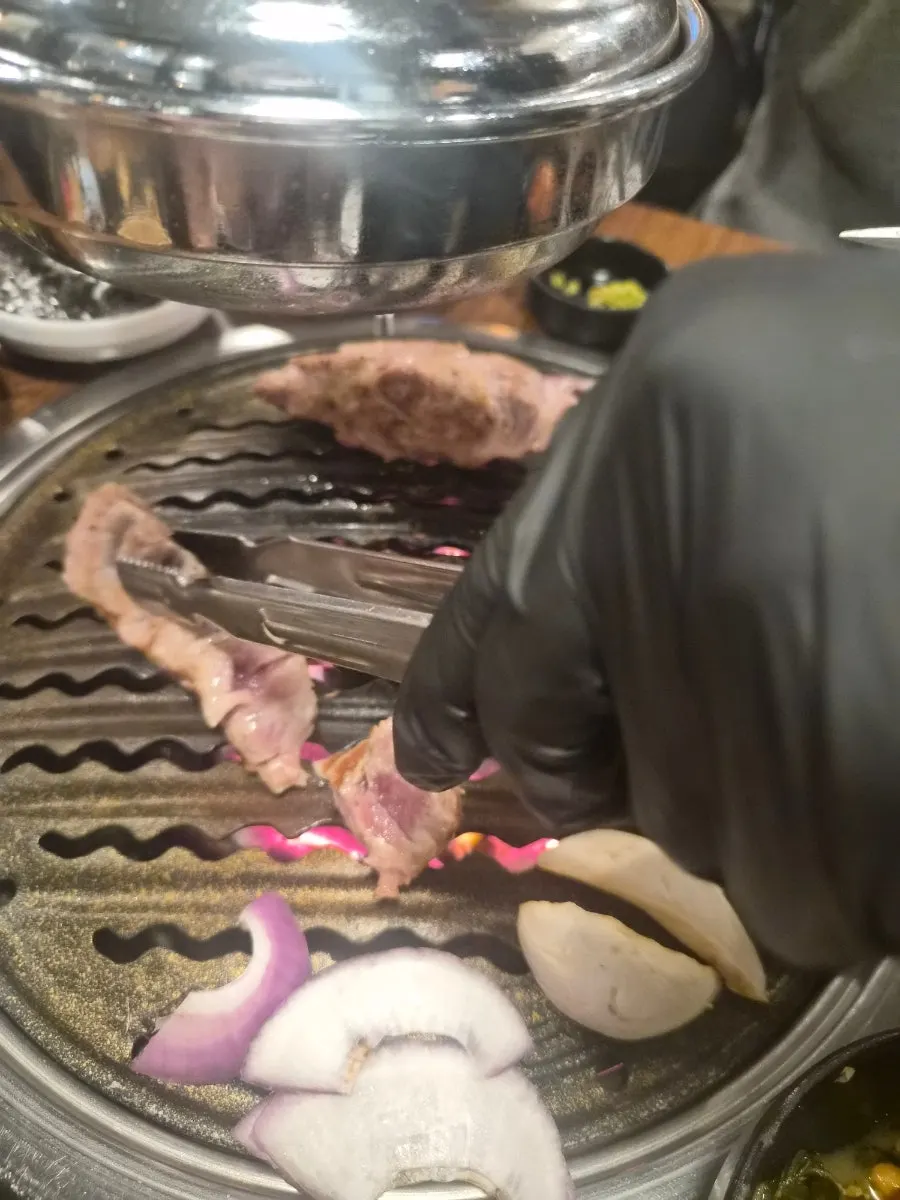 Pork neck being cut into bite-sized pieces