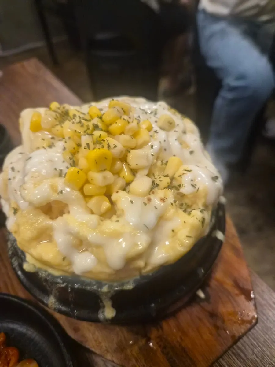 Cheese bomb egg custard topped with cheese and corn