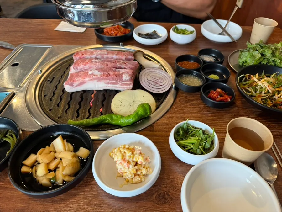 Staff grilling odol samgyeopsal on the pan